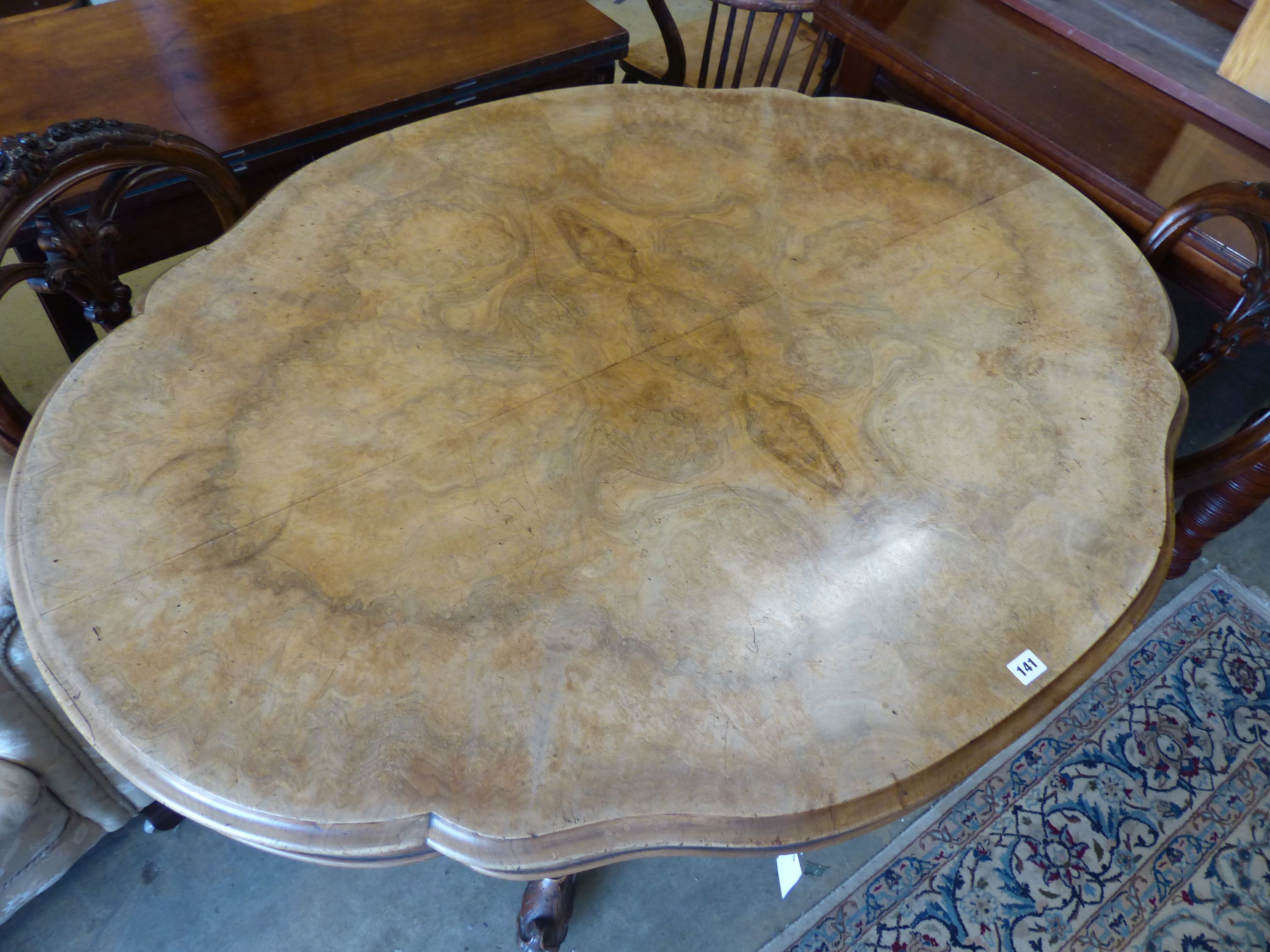 A Victorian figured walnut shaped oval tilt topped loo table, width 134cm, depth 102cm, height 73cm